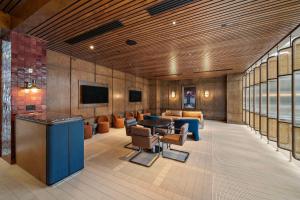 a lobby with couches and a table and chairs at Hilton College Station & Conference Center in College Station