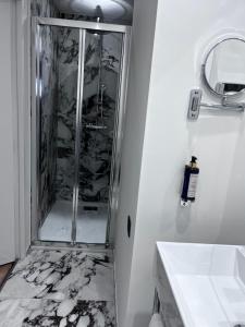 a bathroom with a shower and a sink at Hotel Acadie Eragny in Éragny +35 photos