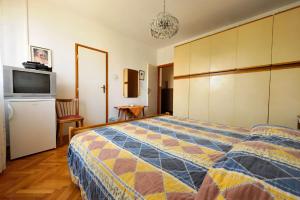 a bedroom with a bed and a television in it at Guest House AB Adria Home in Rovinj