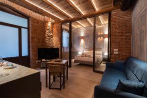 a living room with a blue couch and a bedroom at Emme Loft I Blue Moon - Elegant Luxury Loft Milan in Milan