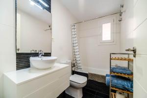 a bathroom with a sink and a toilet at Ático Balinés con vistas al mar in Canet de Berenguer