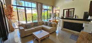 a living room with a couch and a fireplace at 3-bedroom Villa Alanta in Sanur in Sanur