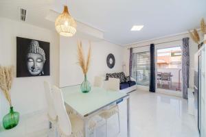 a living room with a table and chairs and a couch at Ático Balinés con vistas al mar in Canet de Berenguer +21 photos