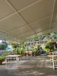 a group of tables and chairs under a large tent at Moliana Bunec in Himare