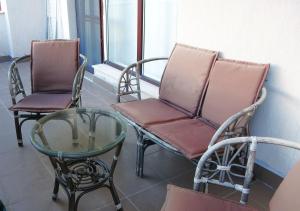two chairs and a glass table in a room at Seafront Apartment im Obzor Beach Resort in Obzor