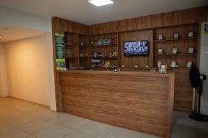 a lobby of a pharmacy with a counter and a tv at Parque Hotel Cordeiro in Cordeiro +37 photos