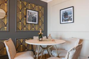 a dining room with a table and chairs at Luxury Monte Carlo- Seaview, Champagne & AC in Beausoleil +9 photos