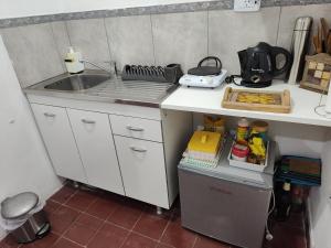 a kitchen with a sink and a counter top at 866 Apart in San Fernando del Valle de Catamarca