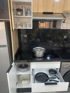 a kitchen with a stove and a counter top at Studio à proximité de tout ! in Fès