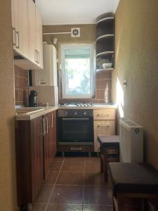 a small kitchen with a stove and a window at Casa Luci in Zalău