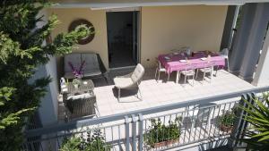 a patio with a purple table and chairs on a balcony at B&B LA CASA DEL CASALE in Roseto degli Abruzzi