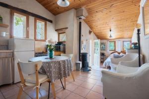 a kitchen and dining room with a table and chairs at Cute stone cottage in Provence in Rivest-Saint-Martin