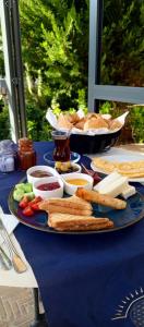 a blue table topped with a plate of bread and dips at Port Hotel, Tasucu in Silifke
