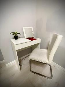a white desk with a chair and a mirror at 22CAP apartment in Milan