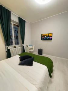 a bedroom with a large bed with a television on the wall at 22CAP apartment in Milan