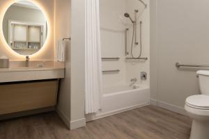 a bathroom with a tub and a toilet and a sink at TownePlace Suites San Jose Campbell in Campbell +29 photos