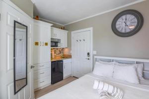 a bedroom with a bed with a clock on the wall at Chagall's Corner in Key West