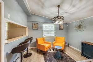 a waiting room with two chairs and a tv at Hike, Golf and Fish Pine Bluff Retreat in Pine Bluff
