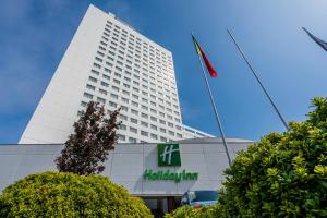 a tall white building with a flag in front of it at Gaia Residence in Vila Nova de Gaia