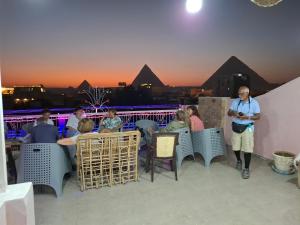 a man standing in front of a group of people on a roof at Gohar Guest House in Cairo