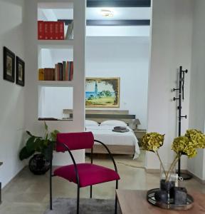 a bedroom with a bed and a red chair at La Maisonette, Florina Center in Florina +27 photos