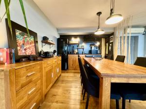 a kitchen with wooden cabinets and a wooden table at Apartament Old City in Timişoara