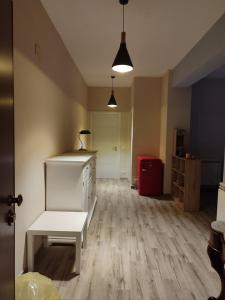 an empty room with a white bench and a red suitcase at San vito 9 in Agrigento