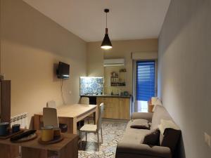 a living room with a couch and a dining room table at San vito 9 - b in Agrigento