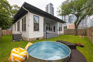 a small house with a hot tub in the yard at Rainey St Retreat - Cowboy Pool & Urban Chic in Austin