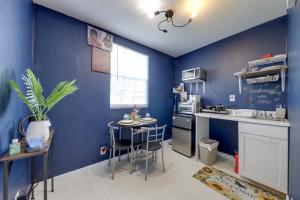 a kitchen with blue walls and a table and chairs at Pet-Friendly Fort Lauderdale Home 8 Mi to Beach! in Fort Lauderdale