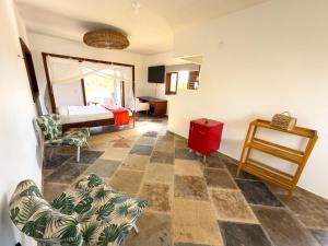 a room with a bed and a table and chairs at Exclusive House Preá in Cruz