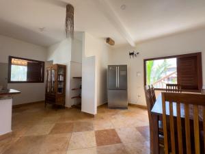 a kitchen with a stainless steel refrigerator in a room at Exclusive House Preá in Cruz