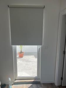 a sliding glass door with a potted plant outside at Casa 18 in Évora