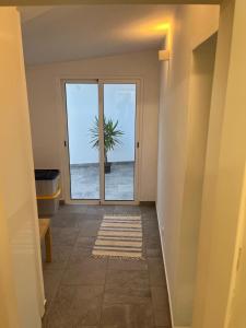 a hallway with a door with a palm tree outside at Casa 18 in Évora