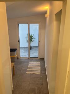 an empty hallway with a door with a palm tree outside at Casa 18 in Évora +3 photos