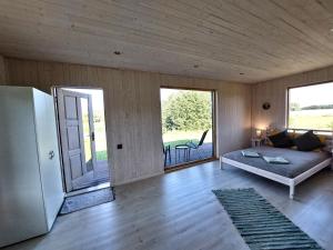 a living room with a couch and a refrigerator at Alchemilla Cabin in Padure
