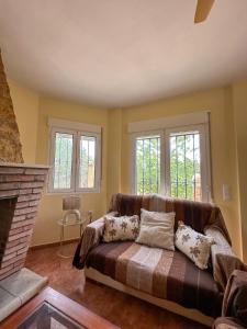 a living room with a couch and a fireplace at Casa Rural El Pomelo in Zurgena +53 photos
