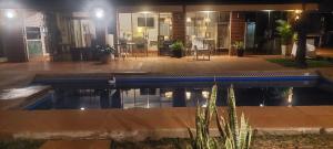 a swimming pool in front of a house at night at LA CASONA jn in Posadas