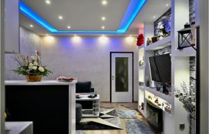 a living room with a blue led ceiling at Apartman Suzii in Pale