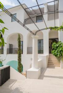 a white house with a swimming pool at Villa Certosa Boutique Hotel Capri in Capri