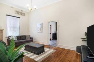 a living room with a couch and a table at Charming! 3 Bed Garden by Beach in Largs