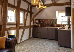 eine Küche mit Holzwänden und Holzschränken und einer Couch in der Unterkunft Maison Da Silva in Oberderdingen