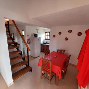 a kitchen and dining room with a table and a staircase at Un lugar en el Mundo in Villa Amancay