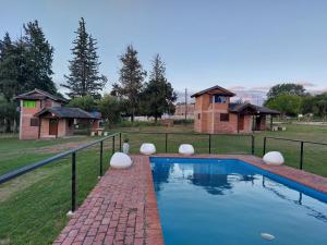 a swimming pool in a yard with a house at Un lugar en el Mundo in Villa Amancay +11 photos