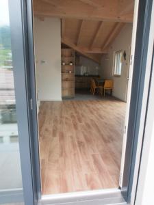a view through a sliding door into a living room at Casa Del Gatto Relax e Natura tra le Dolomiti in Cles