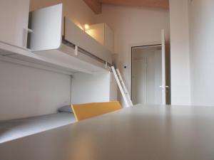 a room with a table and a bunk bed at Casa Del Gatto Relax e Natura tra le Dolomiti in Cles +18 photos