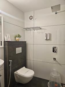 a bathroom with a toilet and a glass shower at S & B Dreams House in Munnar +118 photos