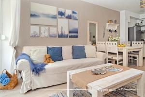 a living room with a white couch and a teddy bear at Uppermill Suite #3 in Pécs