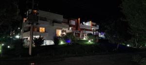 a building at night with lights in front of it at Arena de Mar Depto E in Mar de las Pampas