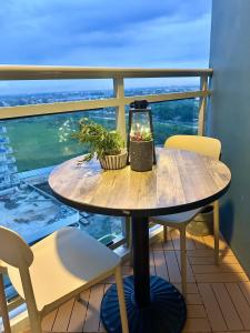 a table on a balcony with a view of the ocean at Studio in Azure North Pampanga in San Fernando